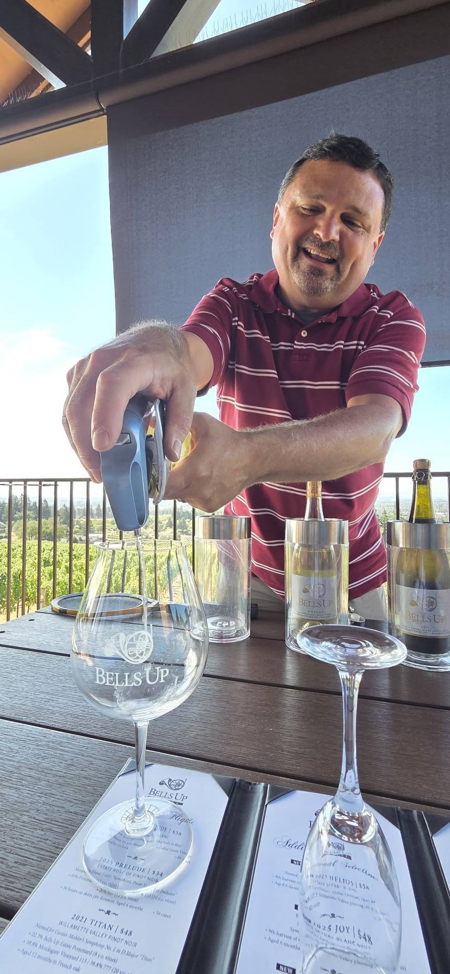 Dave pouring a white wine into a Bells Up glass on the deck