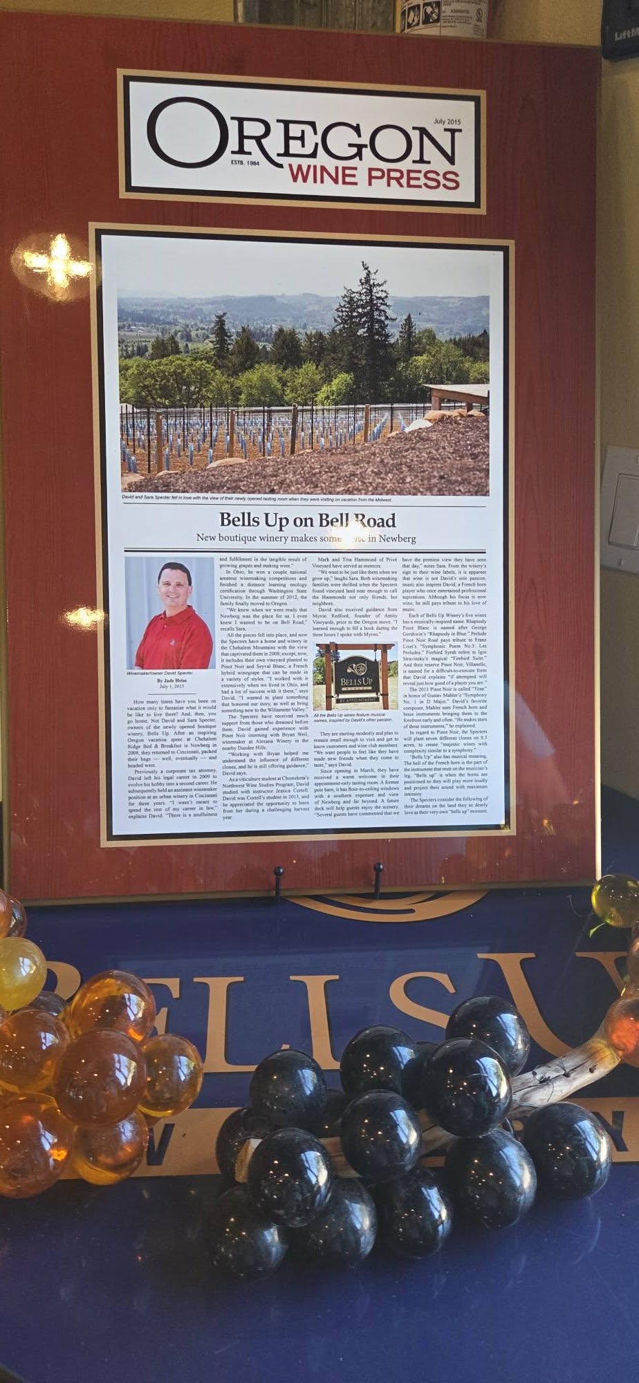 The framed 2015 Oregon Wine Press story "Bells Up on Bell Road" in the tasting room